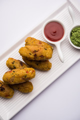 Veg Poha Roll made using flattened Rice, served with tomato ketchup and green chutney