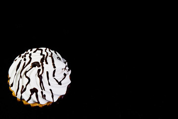 Marmalade under chocolate on dark textile closeup