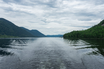 Lake Teletskoye in the mountains. In the evening you can see the hills and nature. Altai region