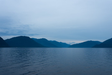 Lake Teletskoye in the mountains. In the evening you can see the hills and nature. Altai region