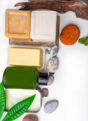 Spa concept. Beautiful composition with cocoa buttet cosmetics for skin care, lotion, soap, butter. Tropical green leaves. Natural organic cosmetics based on cocoa.