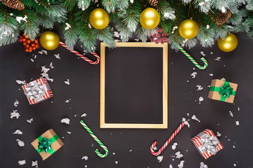 Christmas or New Year black wooden background, Xmas black board framed with season decorations, space for a text, view from above