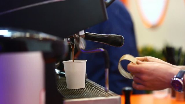 The Barista pours boiling water into a paper Cup