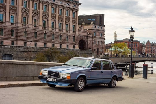 Typical Swedish scene with a historic blue Volvo 740 GLE car in front of the Riksdagshuset building in Stockholm
