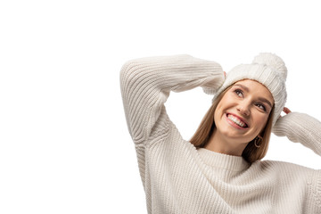 attractive smiling girl posing in white knitted sweater and hat, isolated on white