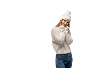 beautiful woman posing in jeans, white knitted sweater and hat, isolated on white