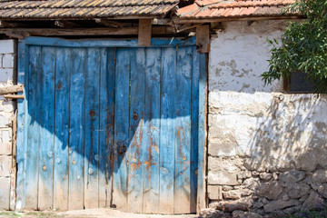 Old blue wooden door and stone wall, tile