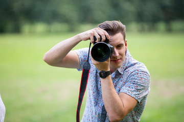 portrait of young photographer take photo at camera 