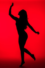 Fototapeta na wymiar black silhouette of sexy woman on red