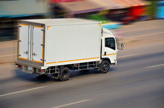 Motion image of the white truck driving with speed
