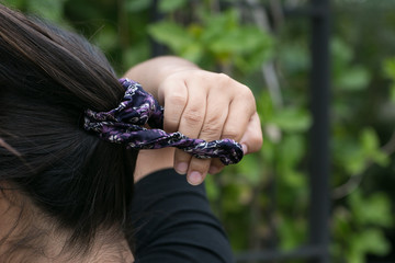 close up of teen girl putting scrunchy in hair