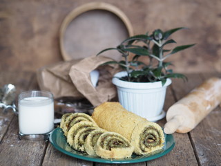 pastry roll on a green plate with ingredients on a brown background