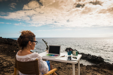 Modern and alternative lifestyle office wokstation with free business woman at work in open office...