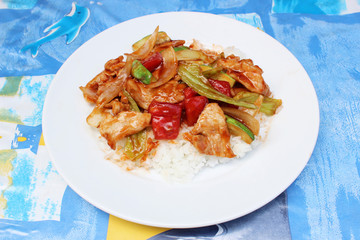 Rice with stir fried sweet and sour sauce with Vegetables and pork on top,Thai food