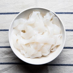 shirataki konjac noodles tagliatelle in a bowl, with chopsticks. low calories diet without carbs