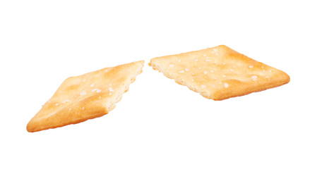 Cracker broken into two halves on a white background