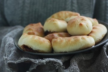 Delicious fresh pies with jam in hand 