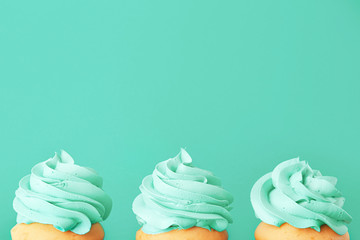 Tasty cupcakes on color background