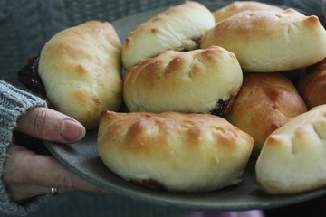 Delicious fresh pies with jam in hand 