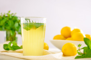 Glass of fresh lemonade on table