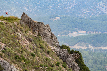 Rocky mountain slopes, sky background in landscape, forest view