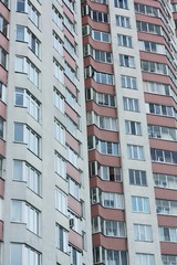 Red white house with windows close up view 