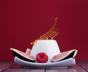 Blancmange dairy healthy dessert with fig and raspberries and dry caramel