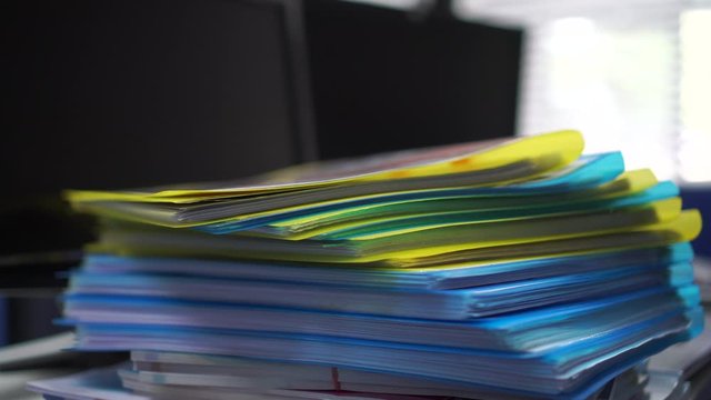 Pile or Stack of file folders with documents binder on desk office. storage archive in business administration management information concept. 4k