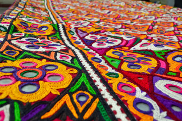 embroidery background,kutch Gujarat indian embroidery background,Frame of embroidery yellow types son  with other flowers mirror work and leaves on cotton cloth