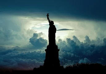 Wall murals Statue of liberty Silhouette of Statue of Liberty over dramatic skies, New York, USA