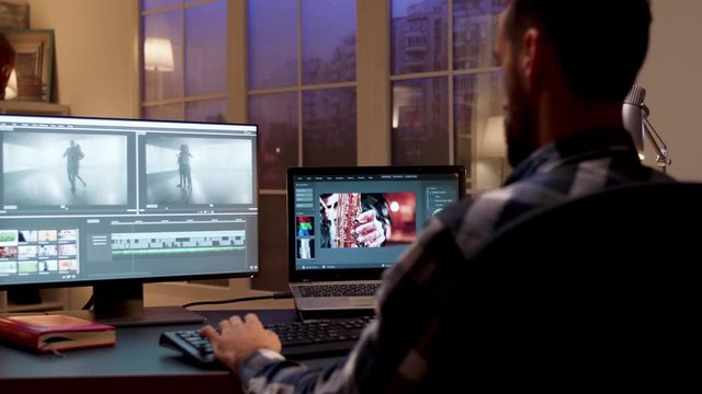 Back view of content creator working in home office