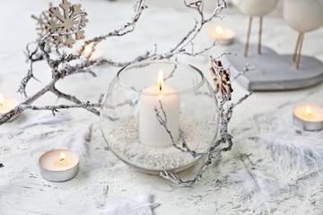 Fototapeta na wymiar Glowing candles with Christmas decor on white background
