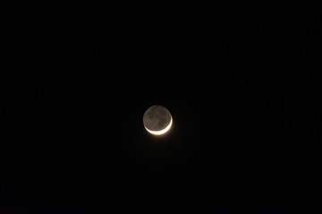 Bright crescent moon in the dark night.