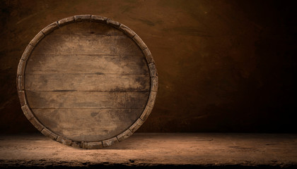 Old wooden barrel on a brown background