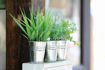 3 zinc plant pots on a white postbox
