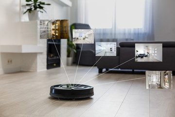 Robotic vacuum cleaner on laminate wood floor in living room - obrazy, fototapety, plakaty