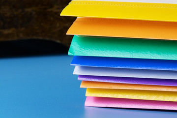 A stack of paper folders on the table.