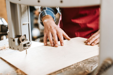 cropped view of craftsman near cnc machine in workshop