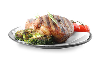 Delicious beef medallions served with vegetables isolated on white
