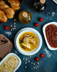 top view of chicken soup and side dishes and bread