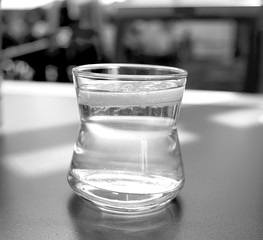 a glass of lemonade stands on a table in a restaurant