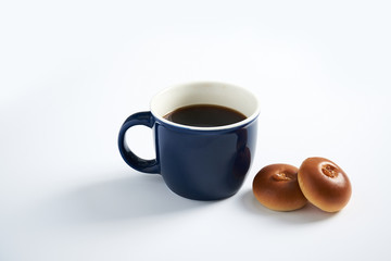 Coffee and Anpan bread on a white background.