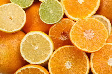 Tangerines and different citrus fruits as background, top view