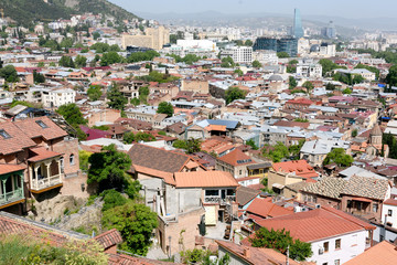 Fototapeta na wymiar Top view on Old Tbilisi with red tiled roofs at sunny day