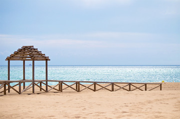 Wooden banisters and pavilion on the beach