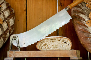 Fototapeta na wymiar Bread and a knife for cutting bread on wooden Board