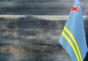 Fragment of the flag of Aruba in the foreground blurred light background copy space