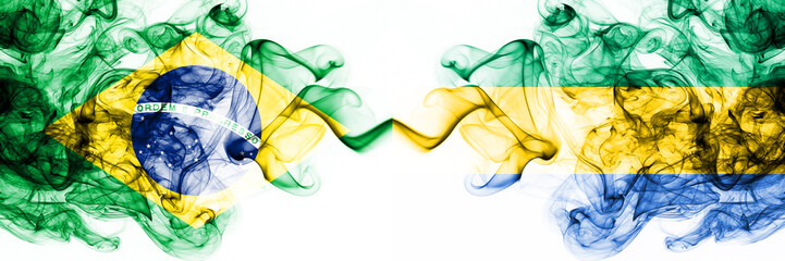 Brazil, Brazilian vs Gabon, Gabonese smoky mystic flags placed side by side. Thick colored silky abstract smoke flags combination