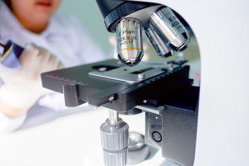 Cropped shot view of  the equipment and science experiments in Laboratory, Chemical substances for research and analyzing a sample under the microscope in laboratory.   