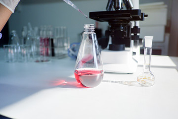 Cropped shot view of  the equipment and science experiments in Laboratory, Chemical substances for research and analyzing a sample under the microscope in laboratory.   
